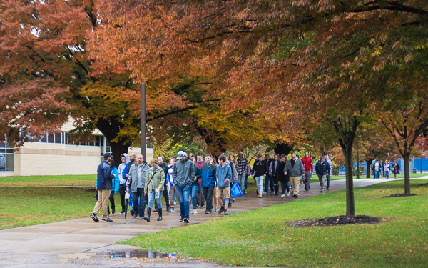 A large tour group follows a student ambassador en route to the Bush Campus Center.
