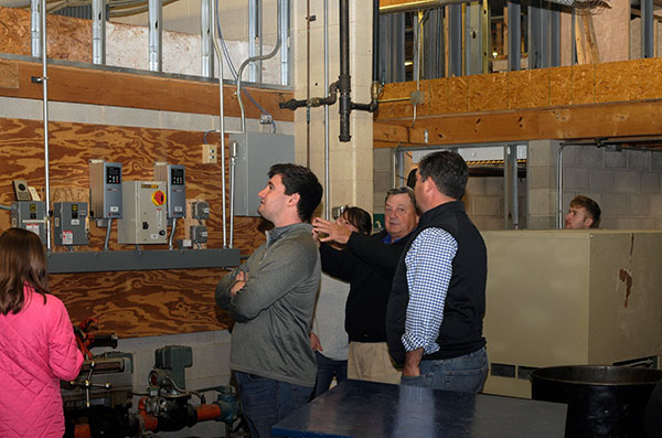 Leading a tour through the double-decker HVAC lab for his family (including a grandfather in the industry) is Nate C. Williamson, of Lafayette Hill, enrolled in heating, ventilation and air conditioning design technology.