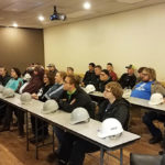 Hard hats at the ready, engineering design technology majors hear from company officials.