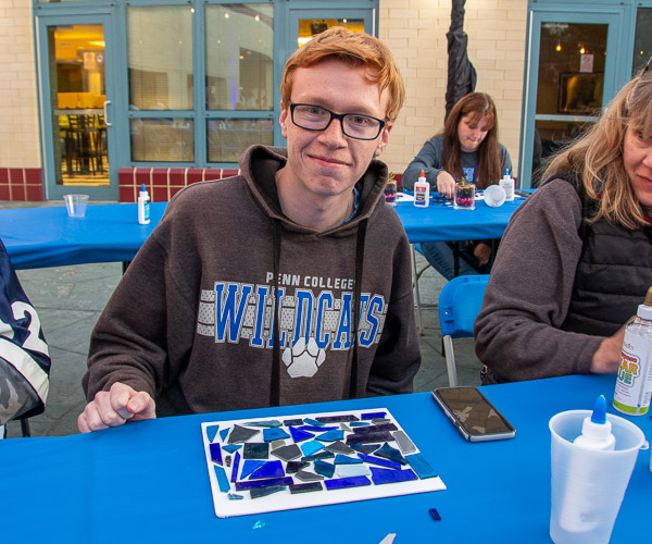 Frank T. Kocsis, a graphic design student from Dickson City, creates a Penn College blue-hued mosaic.
