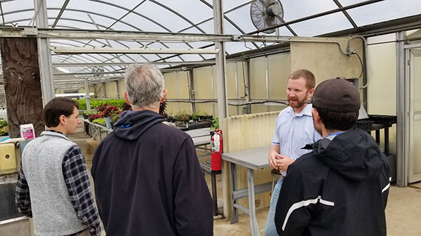 Justin Shelinski, a member  of the horticulture faculty, walks guests through the greenhouses.