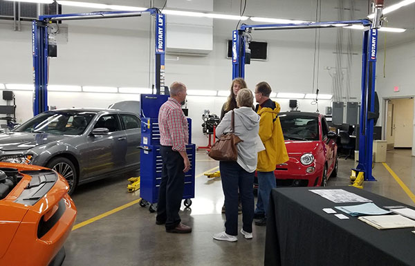 Surrounded by automobiles on which students hone their skills, automotive instructor Christopher A. Trapani ably meets a family's needs.