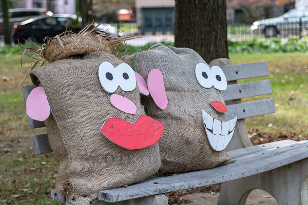 Mr. and Mrs. Potato Head, whiling away an autumn afternoon on a Way's Garden bench