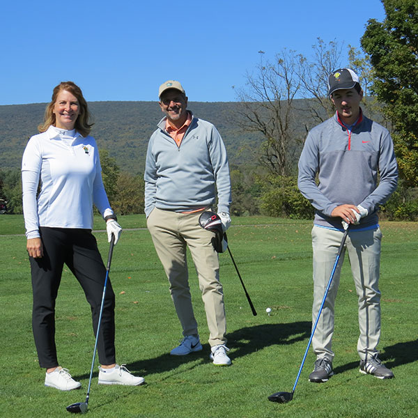 Harrison M. Hanyon (right), a building construction technology major from Broadheadsville, hits the links with parents Connie J. Merwine and Joseph P. Hanyon.