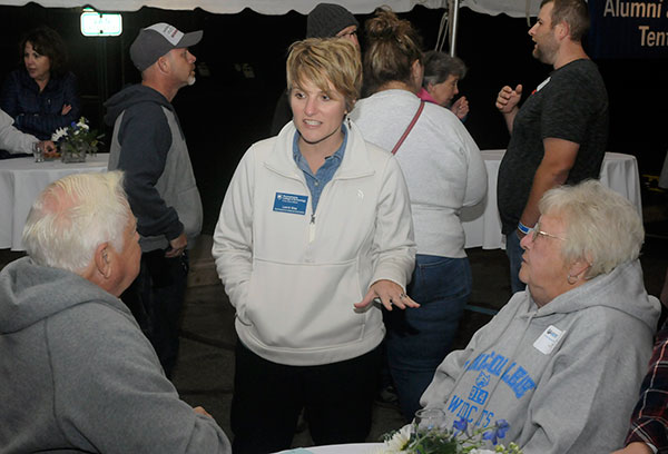 Loni N. Kline, vice president for institutional advancement, talks with McTarnaghan and his wife, Patty, under the Friday night tent.