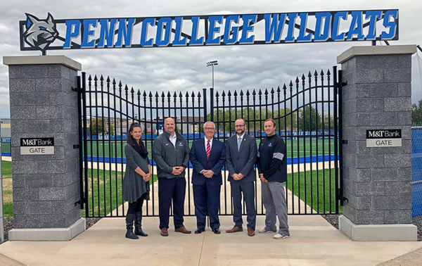 Standing before the impressive M&T Bank Gate are (from left) Christa Matlack, women's soccer coach; John D. Vandevere, director of athletics; Phil Johnson, M&T Bank regional president; Kyle A. Smith, executive director of the Penn College Foundation; and men's soccer coach Tyler S. Mensch.