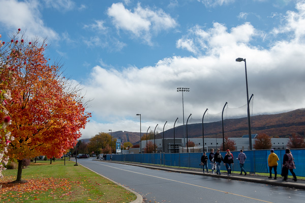Fall foliage, aflame under the return of blue skies, balances families traveling east from Rose Street Commons.