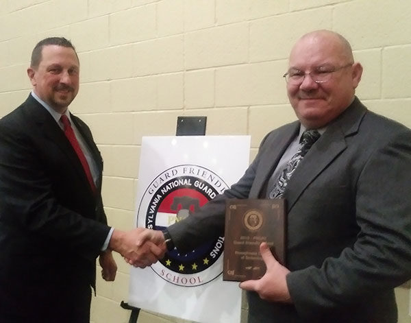 Chester M. Beaver (right), Penn College’s coordinator of veteran and military services, accepts on behalf of the college PNGAS Guard Friendly School designation from the Pennsylvania National Guard Associations. Presenting the honor is retired Brig. Gen. George Schwartz, chairman of the PNGAS Education Action Council. Penn College is one of 30 schools in the state to receive the inaugural designation. (Photo provided)
