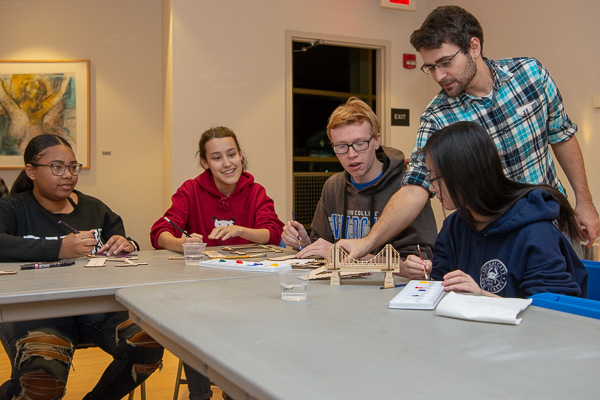 Repko interacts with students during a “Bridging the Gaps” workshop, where participants built bridges representing the past, present and future as they relate to the artist’s work.