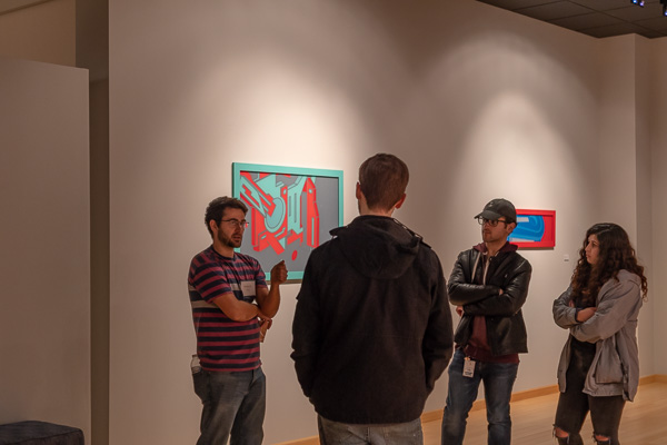 Surrounded by striking examples of his work, Repko talks to guests about the exhibit's genesis.