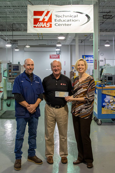 Ken Wawrzyniak, sales engineer for Haas Factory Outlet, presents a $15,000 grant check to Pennsylvania College of Technology on behalf of the Gene Haas Foundation. The grant will support scholarships for manufacturing students, as well as student competition teams. Accepting the grant on behalf of Penn College are Richard K. Hendricks, instructor and department head of automated manufacturing and machining, and Elizabeth A. Biddle, director of corporate relations.