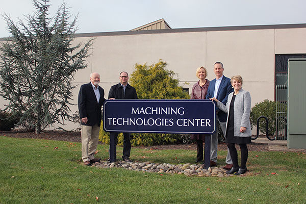 Standing outside the future Larry A. Ward Machining Technologies Center, where a new sign – the ultimate winner in a pending student design contest - will designate the ongoing work inside the building, are (from left) Ward; Howard W. Troup, instructor of automated manufacturing/machine tool technology; Elizabeth A. Biddle, director of corporate relations; Michael J. Reed, vice president for academic affairs/provost; and Loni N. Kline, vice president for institutional advancement.