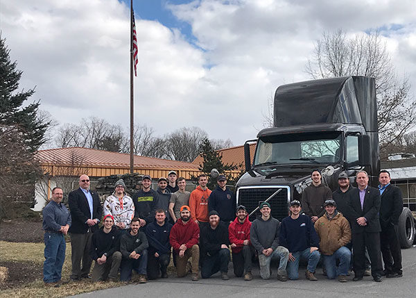 Students, faculty and UPS Freight representatives – including two Pennsylvania College of Technology alumni – gather with a retired vehicle donated to the college. Joining students outside the Schneebeli Earth Science Center are (at left) Mark E. Sones, instructor of diesel equipment technology, and James R. Poehailos, UPS Freight fleet manager; and (at right) 1983 automotive technology alumnus Gregory A. Tama, retired senior director of maintenance, engineering systems and technology, and 1992 diesel technician graduate Scott C. Moore, district fleet manager. (Photo by Marci M. Hessert, secretary to the School of Transportation & Natural Resources Technologies)