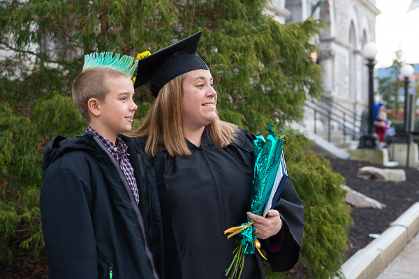 'Tis the season for green! Kendra S. Brown and son pose for photos; she earned a bachelor’s degree in business administration: management concentration.