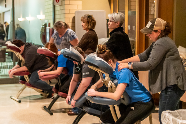 Relief at their fingertips! A team of massage therapists makes the anxiety melt away.
