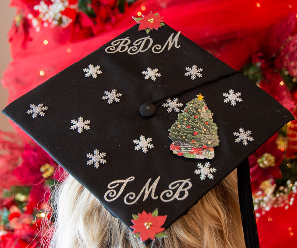 Taylor M. Bickhart, an applied management graduate from Middleburg, adds a festive finish to her cap. She also holds a degree in baking and pastry arts.