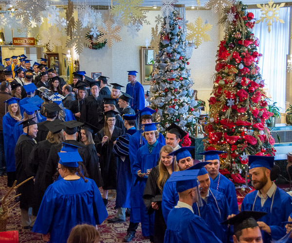 The Genetti Hotel lobby provides a seasonally merry backdrop for the graduates to stage before departing for the Community Arts Center.
