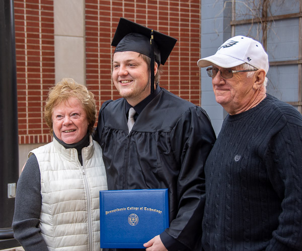Ethan I. Smeigh, New Bloomfield, celebrates a degree in building science and sustainable design: architectural technology concentration with his grandparents.