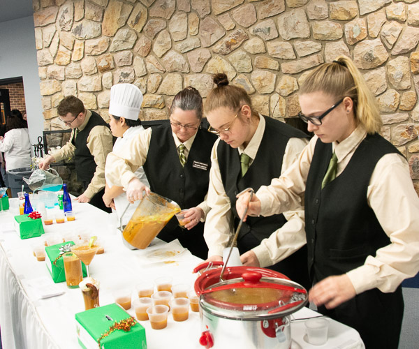 Students in Hospitality Beverage Management Service and Controls prepare nonalcoholic mixed drink samples as high school students peruse the Food Show. From left are Chad R. Biichle, of Watsontown; Madison Y. Cooper, of Harrisburg; Jeanne L. Booth, of Williamsport; Angela M. Linde, of Harrisburg; and Summer L. Showers, of Aspers.