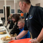 Nourishing plates are brought to the table by Timothy O. Rissel, executive director of General Services – honoring the "service" portion of his job title.