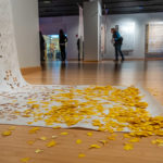 Hand-cut “ginkgo leaves” spill out from the base of one of the artist’s lace-like works.