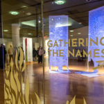 The exhibit title on gallery glass invites artistic exploration. 