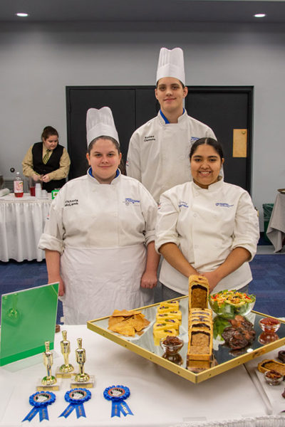 Winners of the Chef Eugene Mattucci Best of Show award at Pennsylvania College of Technology’s annual Food Show are, from left, Victoria J. McLamb, of Williamsport; Keowa A. Clemens, of York; and Sherly F. Mendez, of Tobyhanna. The students teamed up to create a “Fiesta!”-themed cold platter and charcuterie board display.