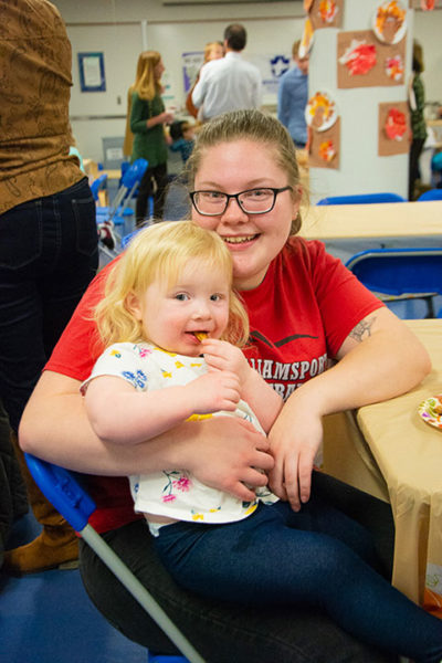 Pennsylvania College of Technology student Mariah N. Marshall, a human services and restorative justice student from Williamsport, celebrates with her daughter during an event at the college’s Dunham Children’s Learning Center. The center received a Child Care Access Means Parents in School grant from the U.S. Department of Education to help reduce fees for students whose children are enrolled at the facility. 