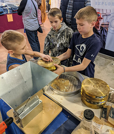 Cai Cassel (right), a son of the college's alumni relations director, so enjoyed a science activity that he stayed on to demonstrate for other youngsters. 