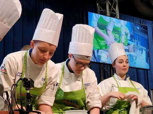 From left: Abby E. George, of Harrisburg; Kaitlyn M. June, of Muncy; and Alexa D. Scatamacchia, of Fleetwood, are all business during the students' culinary competition. George is a baking and pastry arts student, June majors in culinary arts technology and Scatamacchia is enrolled in applied management.