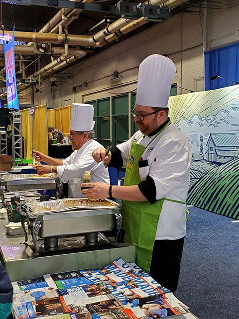 With students busily preparing for competition, Chefs Mike J. Ditchfield (left) and Christopher R. Grove dish out some of the many samples provided to the public throughout the Farm Show's opening weekend.