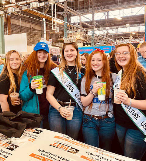 Wearing Penn College attire, Pennycoff's children join friends (in Miss Agriculture sashes) – all involved in 4-H Club – at the Farm Show Complex. 