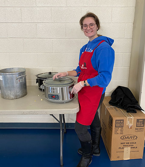 Serving up samples of the food being distributed is Olivia C. Ferki, a student development assistant from Richboro.