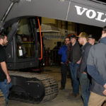 Diesel Engines Laboratory students of Jeremy R. Bell (at center, in blue shirt) gather around a Volvo EC140EL excavator.