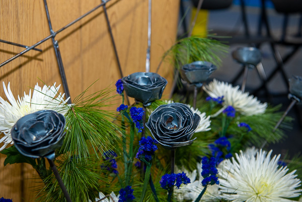 An array of metal roses, crafted by welding students, adds floral décor to the dais.<br />
