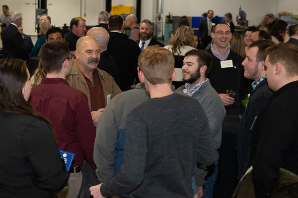 Wayne Leone from Talen Energy (at left, facing the camera) enjoys conversing with students. 