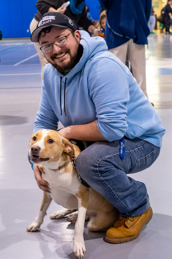 Dexter, the canine companion of Cathy E. Gamez, Rose Street Commons hall coordinator, is never far from a willing student handler. Joining him in the Field House is Resident Assistant Kyle T. Hansen, a building automation technology student from Waldwick, N.J. 