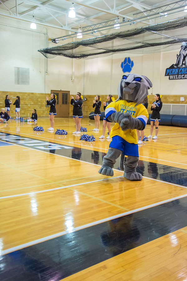 Cheerleaders and their beloved mascot add the week's signature hue to their customary team colors.