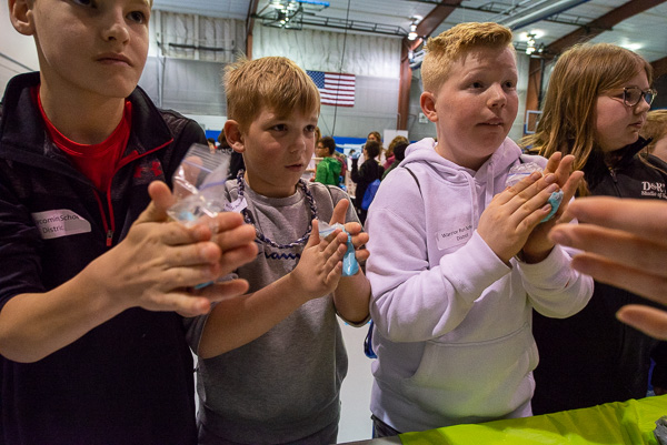 That slime is mine! Kids knead small plastic bags filled with slime solution at an exhibit sponsored by the Society of Plastics Engineers’ PlastiVan program.