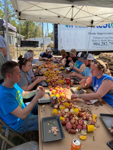 The group enjoys a traditional slow country boil lunch on its last day.