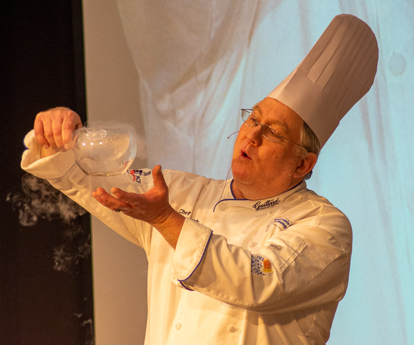 Before revealing its effects on Teddy Grahams, Suchwala shows the crowd how liquid nitrogen boils and  produces vapor at room temperature.
