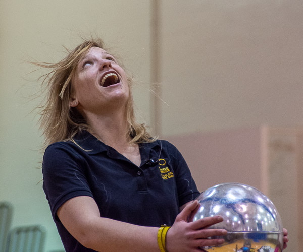 The Franklin Institute educator tries to catch a glimpse of her hair as the buildup of electrical charges in a Van de Graaff generator makes it stand on end. 