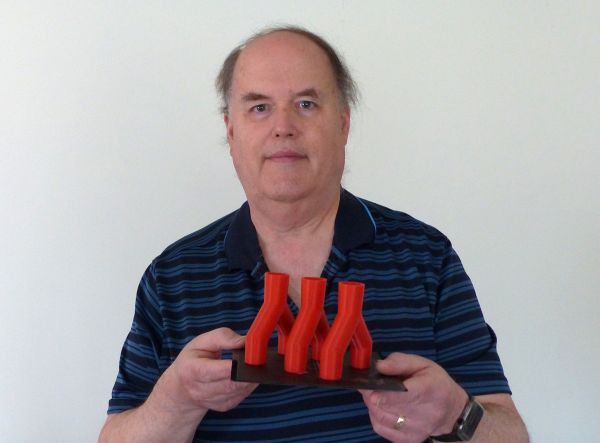 Eric K. Albert, associate professor of automated manufacturing at Pennsylvania College of Technology, holds three of the eight vent splitters he made with his home 3D printer in response to the COVID-19 pandemic. Albert followed directions provided by ventsplitter.org to manufacture the splitters, which are awaiting emergency FDA approval. As a last resort, the vent splitter allows multiple patients to share one ventilator.