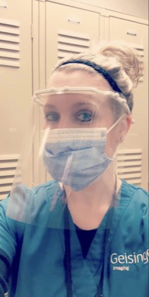 Geisinger Radiology's Jessica K. Kemock dons one of the face shields to be fashioned from college-donated transparency sheets. (Photo provided)