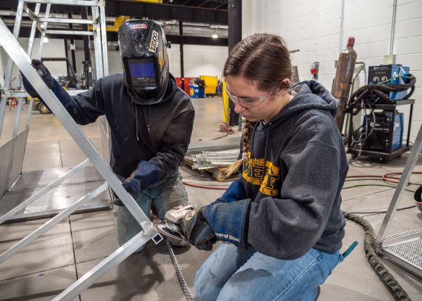Welding students Axel A. Murillo and Sara D. Stafford take respite from Finals Week to work on the Living Chapel.