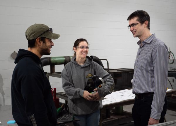 Murillo and Stafford proudly discuss the Penn College welding program with Australian-Canadian music composer Julian Revie, the creative director of the Living Chapel. 