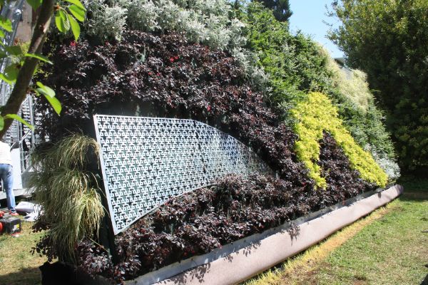 A decorative metallic piece crafted at Penn State complements one of the “plant walls.”
