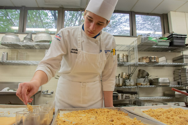 Becker adds a layer to an authentic Italian dessert during a Spring 2019 visit to campus by Chef Felice Santodonato, a professor of enogastronomy at the University of Rome.
