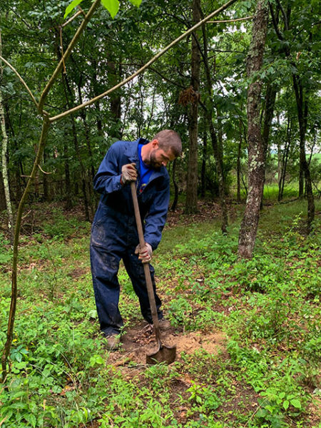 ... and classmate James A. Hardman, of Trout Run, help to plant seedlings at Trailing Pines Tree Farm in Muncy.