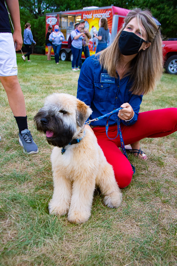 Walter, a soft-coated wheaten terrier (and acknowledged bundle of hugs) greets guests with owner Katie L. Mackey, assistant director of disability services.